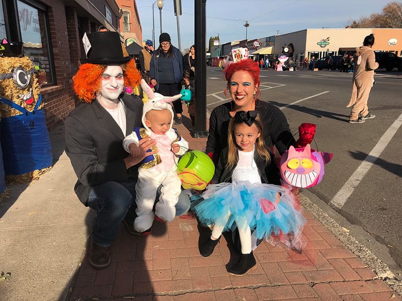 family dressed up for Halloween on sidewalk